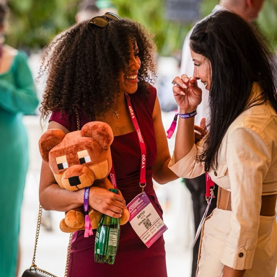 ArtsyMeta (@ArtsyMeta) laughing in conversation while holding a Doginal Dogs plush
